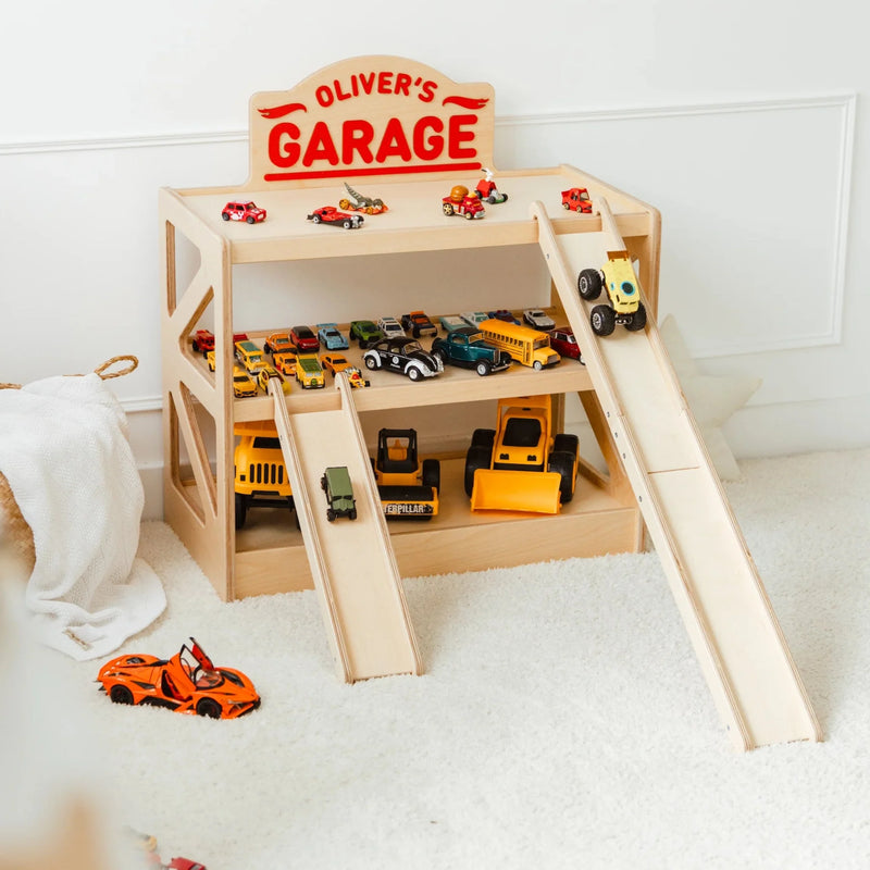 Light wood personalized toy car garage with the name 'Oliver's Garage', three tiers filled with toy cars and two ramps