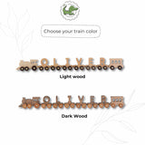 A product color selection graphic showing a wooden name train color options such as 'Light wood' and 'Dark wood'