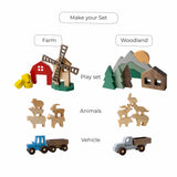 Collection of wooden toys including a windmill, barn, animals, and vehicles on a white background.