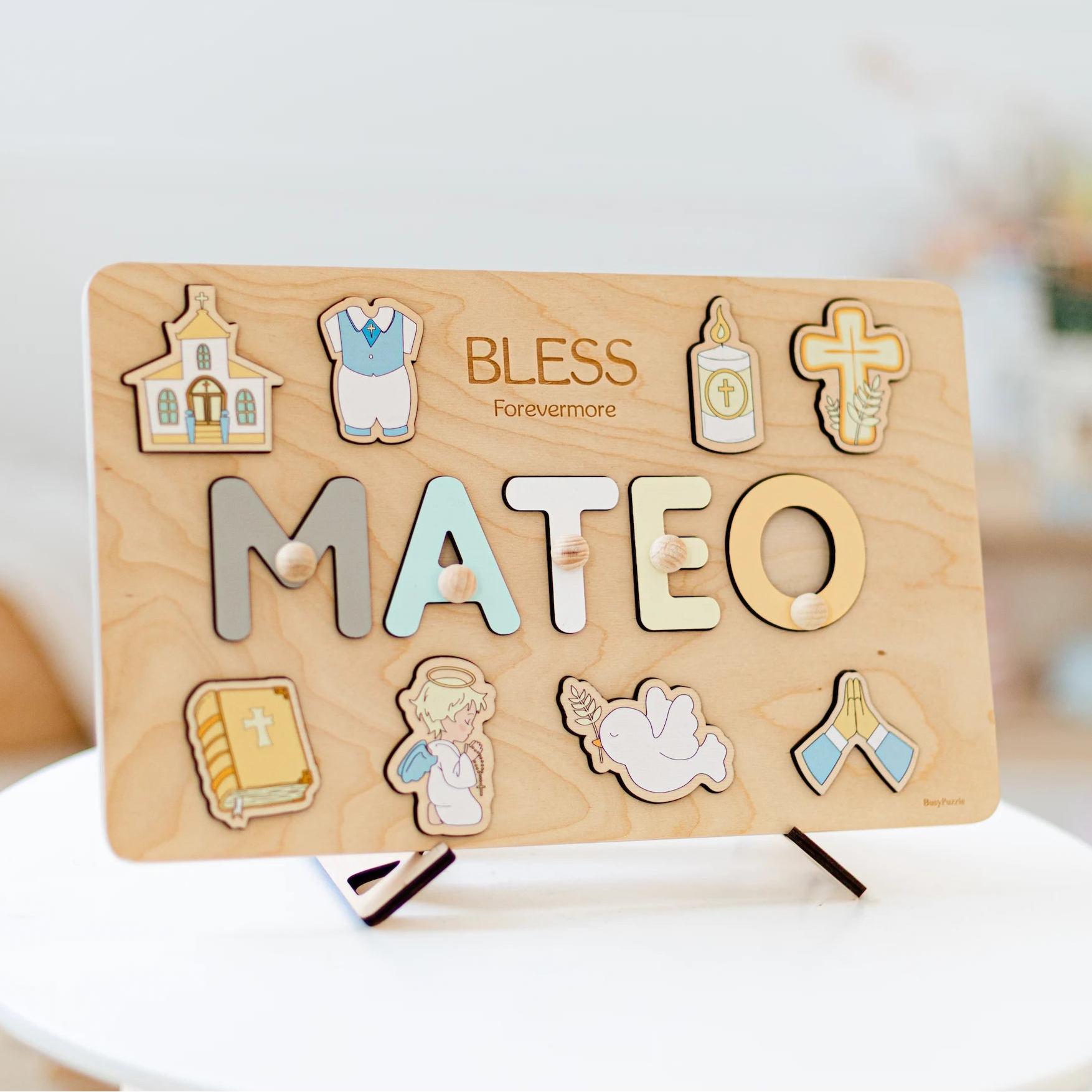 Wooden name plaque with decorative elements and 'BLESS Forevermore' text on a stand.