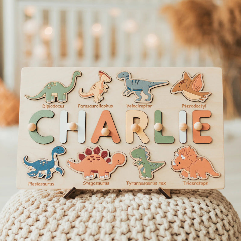 Wooden name puzzle with dinosaur designs on a textured surface