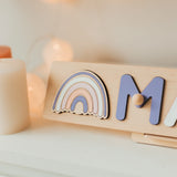 Wooden name puzzle with a rainbow element on a neutral background