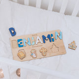 Wooden name puzzle with colorful letters on a white blanket