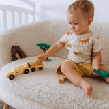 Child playing with wooden toys on a soft surface