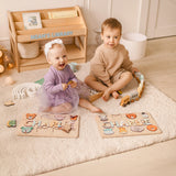 Two toddlers playing on the floor near a light wood personalized bookshelf named Noah's Library