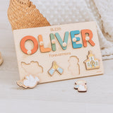 Wooden name puzzle with colorful letters spelling 'OLIVER' and cut-out shapes on a light background.