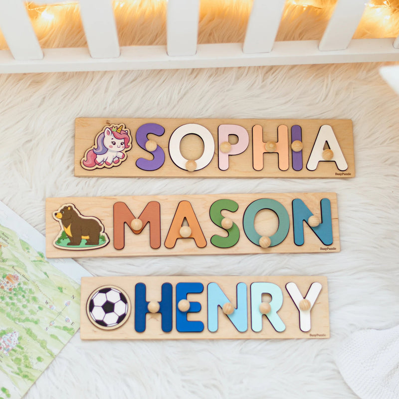 Three wooden name puzzles with colorful letters spelling 'SOPHIA', 'MASON', and 'HENRY' on a light background.
