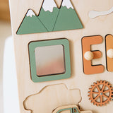 Wooden name board with letters, shapes, and a gear