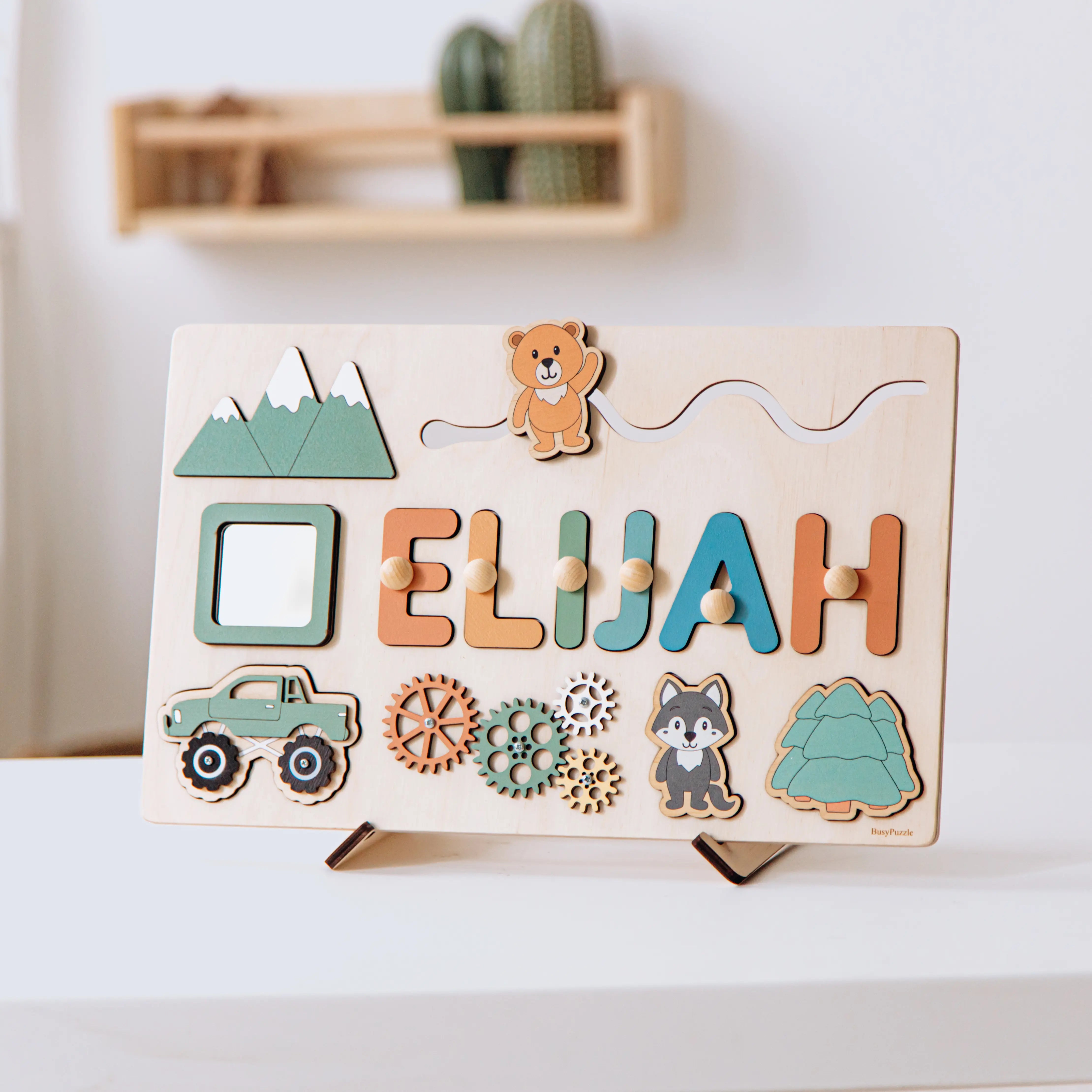 Wooden name puzzle with colorful letters spelling 'Elijah' and various shapes on a stand.