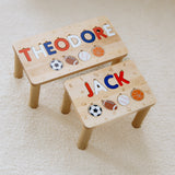 Two wooden stools with names 'THEODORE' and 'JACK' and various symbols on a light background.