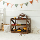Dark wood personalized toy car garage named Henry's Garage beside a crib with toy vehicles
