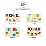Four wooden name boards with sports-themed designs on a white background.