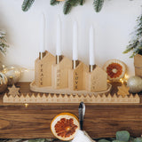 Wooden advent calendar with candles on a festive background