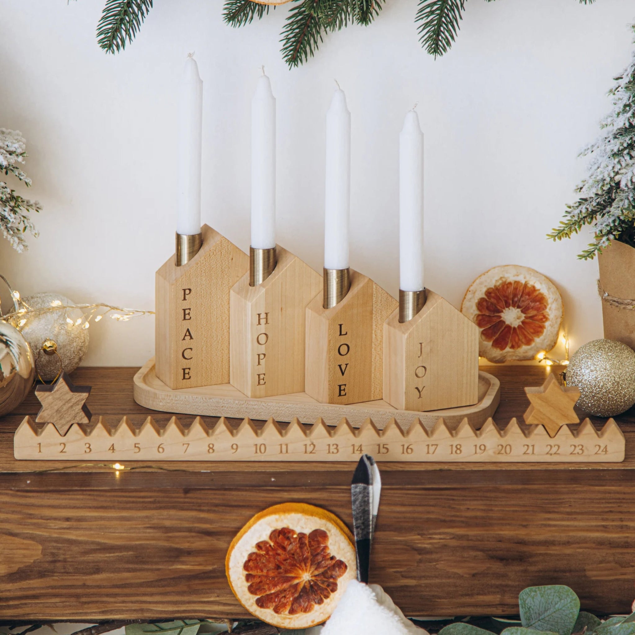 Wooden advent calendar with candles on a festive background