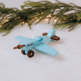 Blue personalized wooden toy plane with pine branch decoration