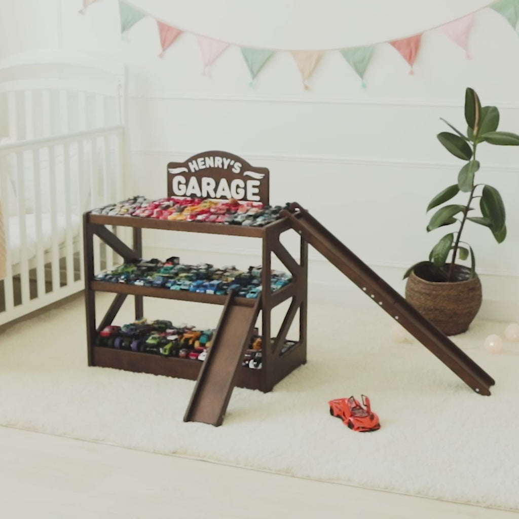 Dark wood personalized toy car garage named Henry's Garage with ramps in a nursery
